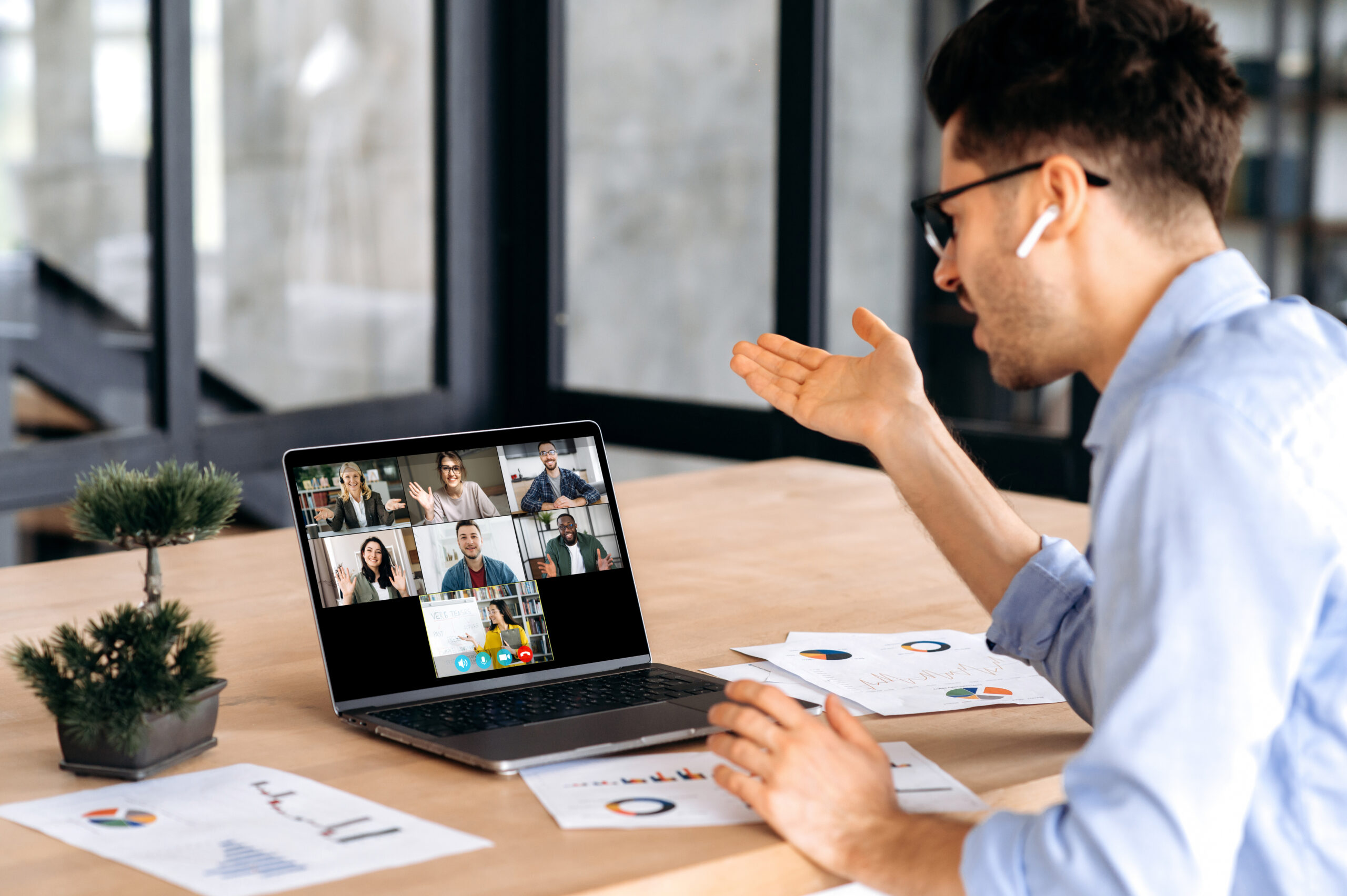 Online education, e-learning concept. Smart caucasian guy gains knowledge watching lesson online and learning distantly. Young man listening lecture from female teacher on video call using laptop