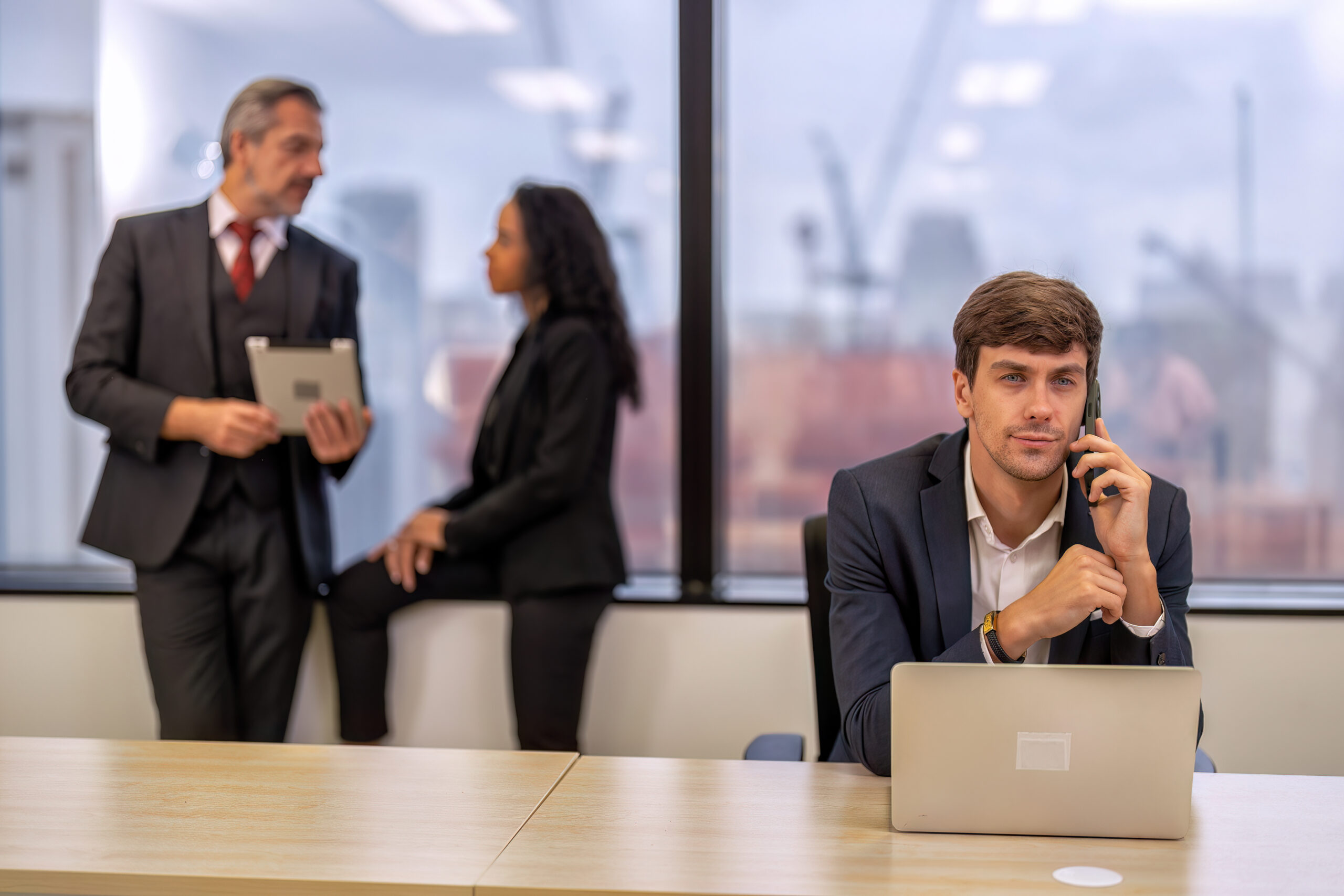 Staff employee sitting use mobile phone call in work place